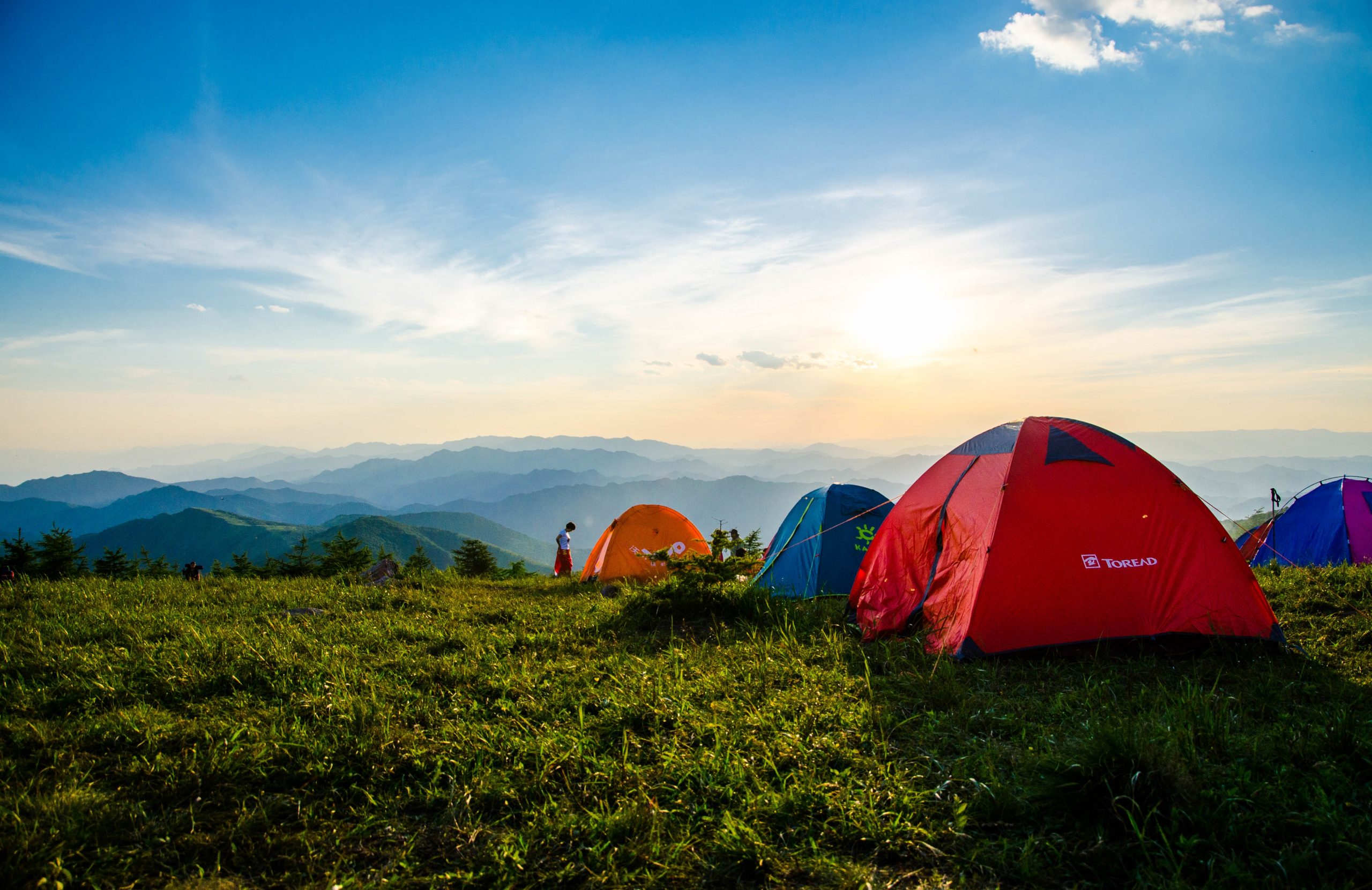 photo-of-pitched-dome-tents-overlooking-mountain-ranges